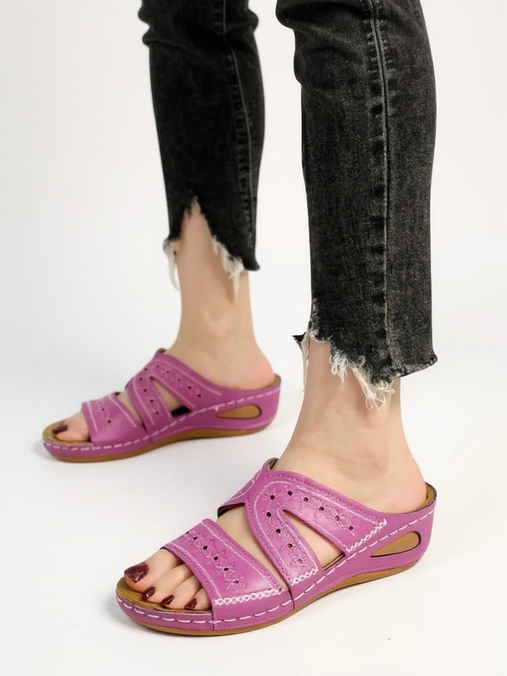 Margaux embroidered sandals in rose laid flat on a sun-drenched surface