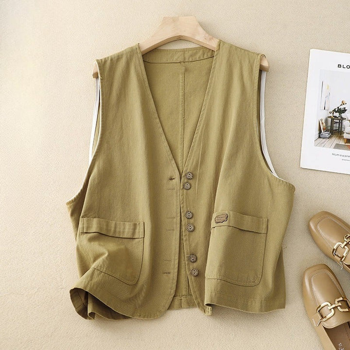 Close-up detail of rustic-inspired front buttons and patch pocket on the relaxed vest