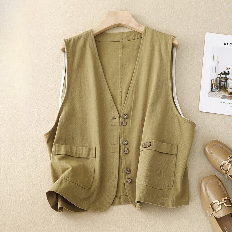 Close-up detail of rustic-inspired front buttons and patch pocket on the relaxed vest