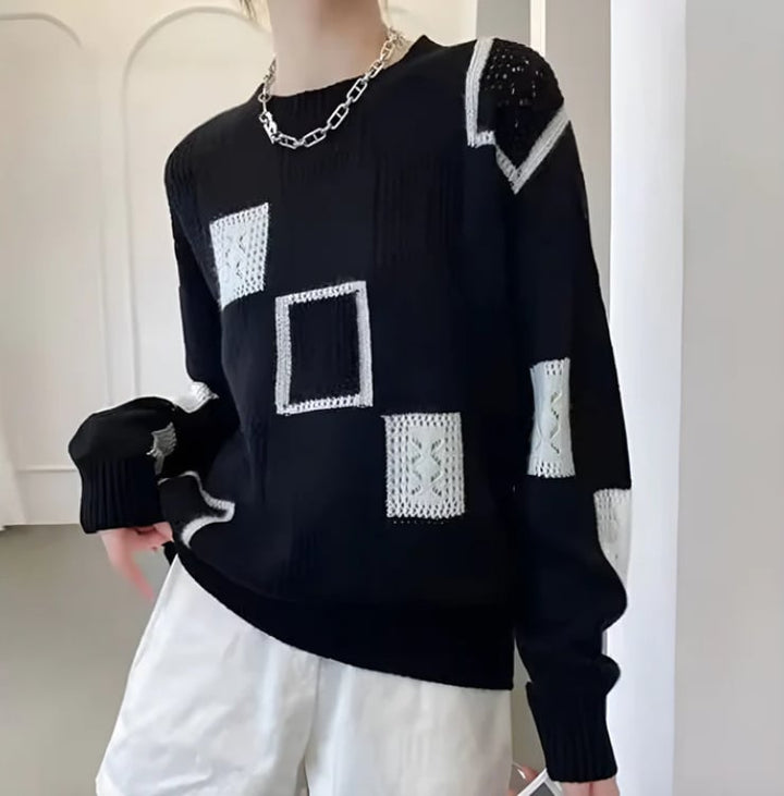 Close-up of patchwork sweater showing ribbed texture and refined stitching detail