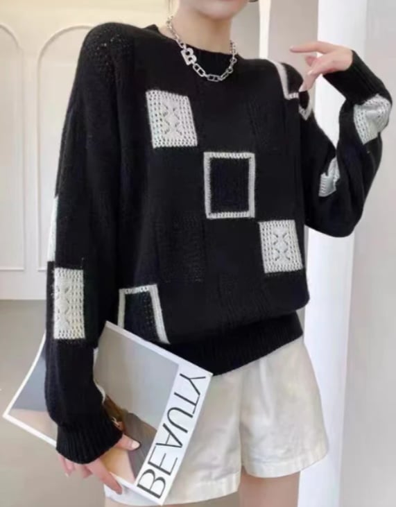 Side view of woman wearing a fitted patchwork sweater showing silhouette and length