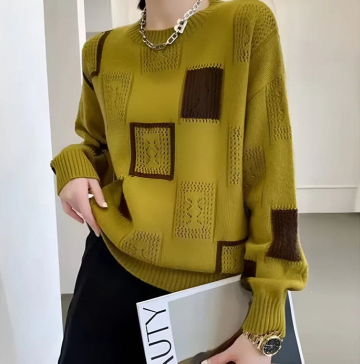 Model wearing patchwork sweater styled with a midi skirt for a dressed-up cold-weather outfit