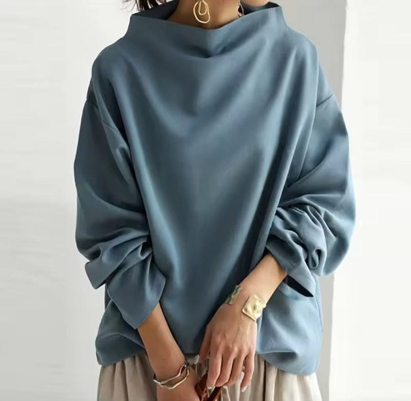 Close-up of the soft knit fabric and chic high neckline on the Margot top in black