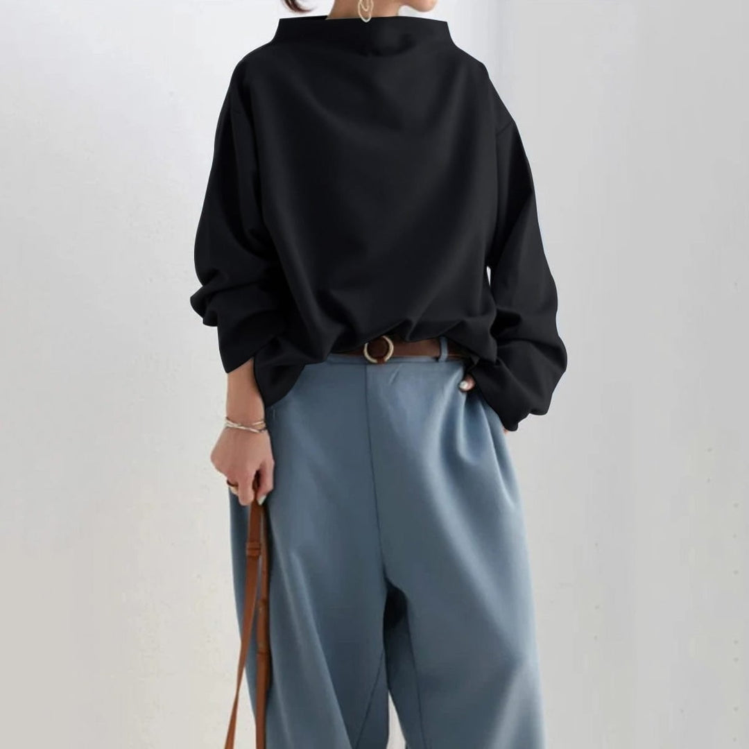 Detail shot of the high neckline and sleeve length on the Margot knit top in blue