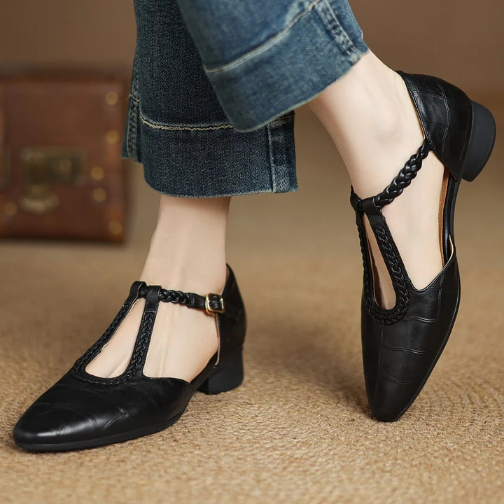 Margot leather T-strap mary jane flats in black with pointed toe and braided strap, front view