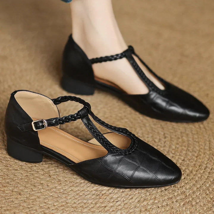 Margot leather T-strap mary jane flats in black, side profile showing flat cushioned sole