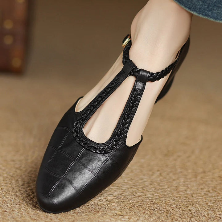 Close-up of braided T-strap and metal buckle detail on Margot mary jane flats in black