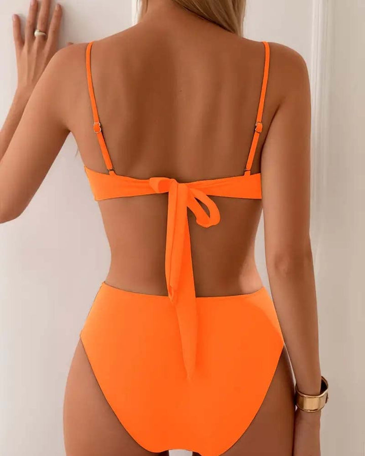 Model wearing the Marguerite flattering bikini set in brown on a beach