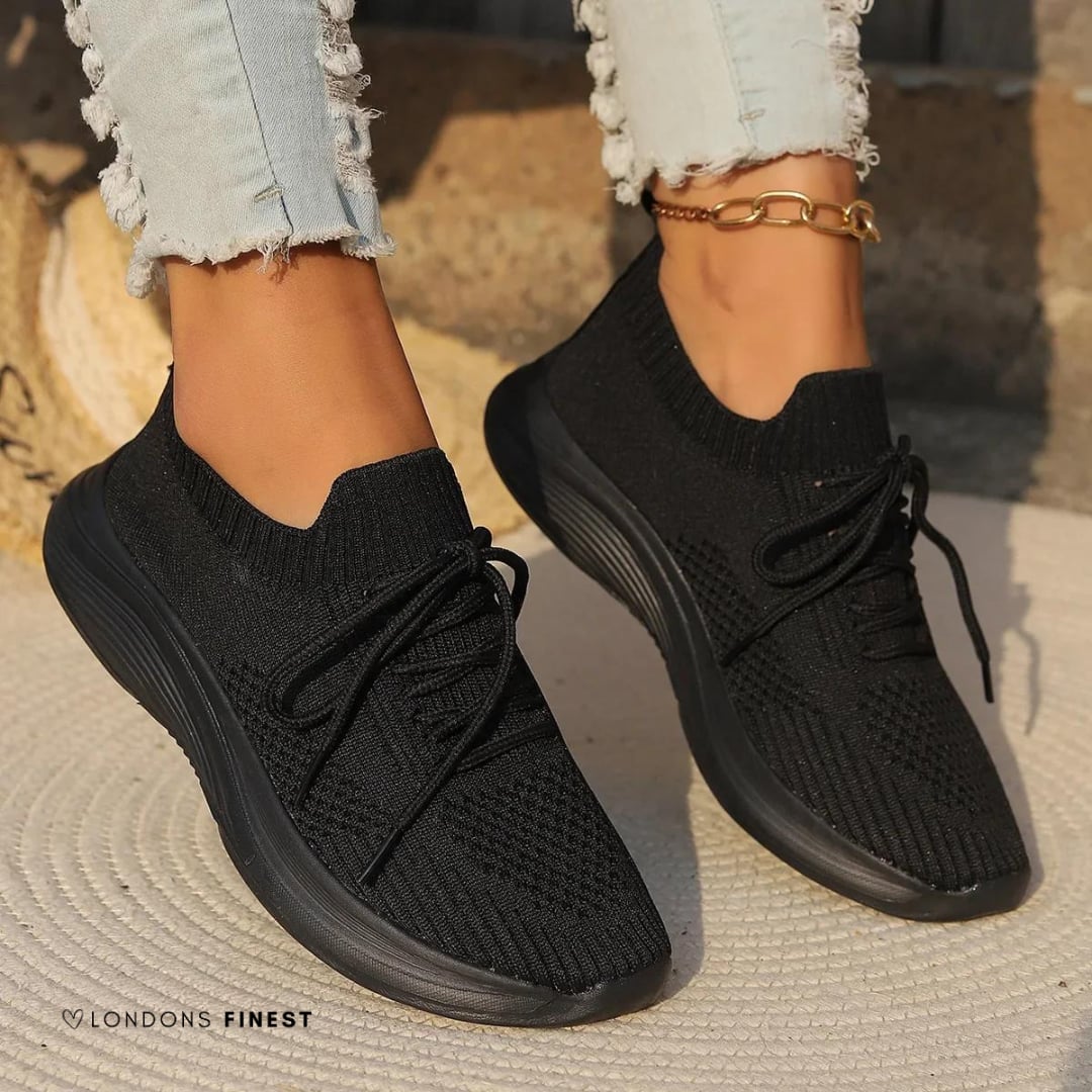 Marguerite women's orthopedic sneakers in black displayed on a clean background highlighting shock-absorbing outsole detail