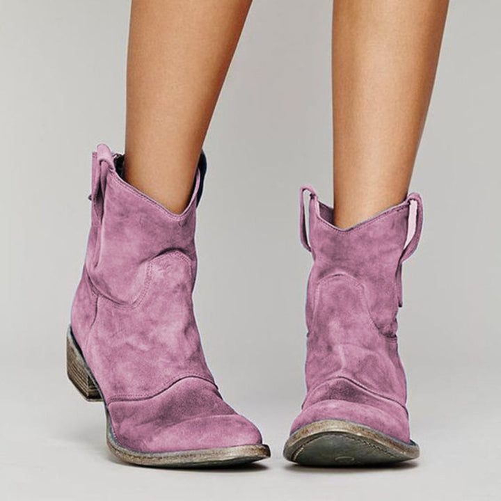Women's suede ankle boots in purple showing smooth contours and supportive sole