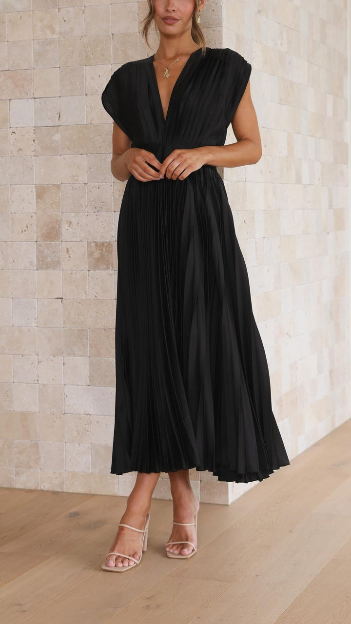 Close-up of black pleated maxi dress showing fabric quality and pleat detail