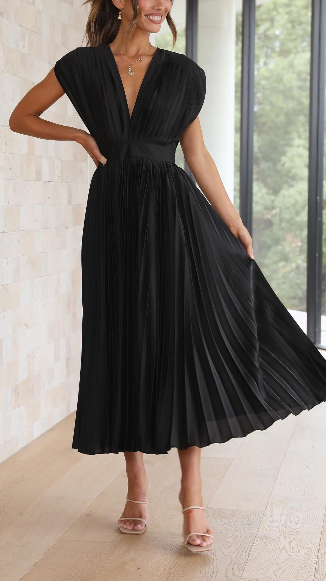 Back view of model in black elegant pleated maxi dress