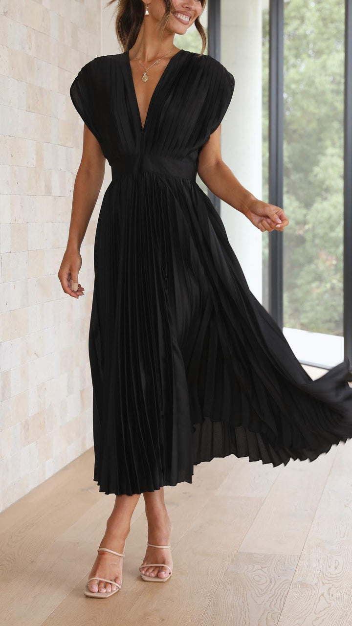 Front view of grey pleated maxi dress on model showing flattering high-waisted design