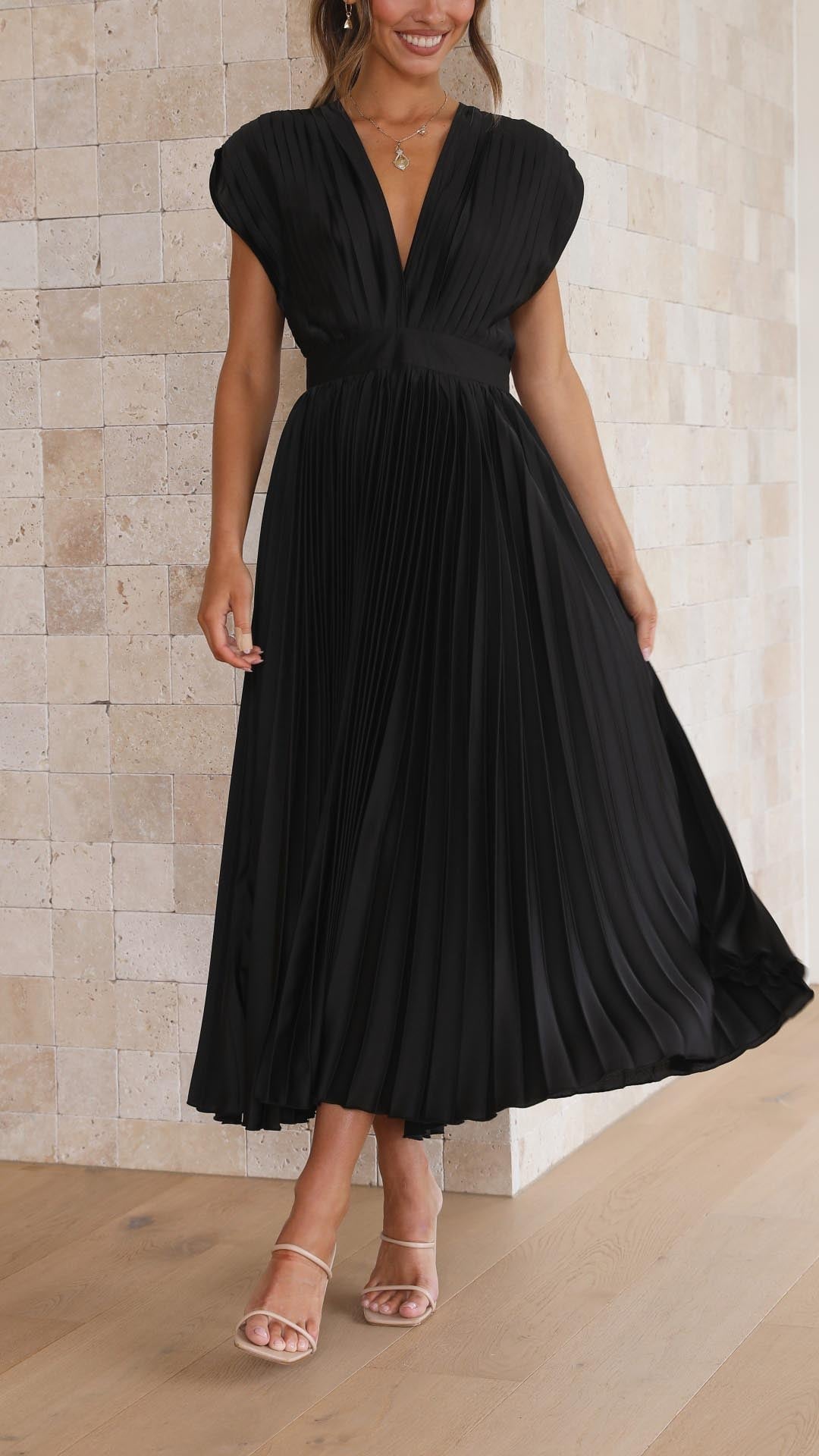 Close-up of grey pleated maxi dress fabric and graceful pleat detailing