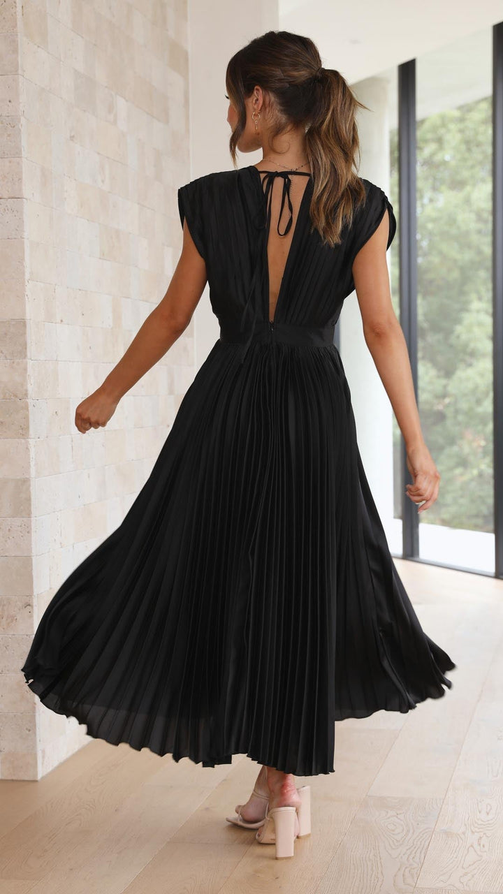 Side view of model in grey pleated maxi dress showing full-length silhouette