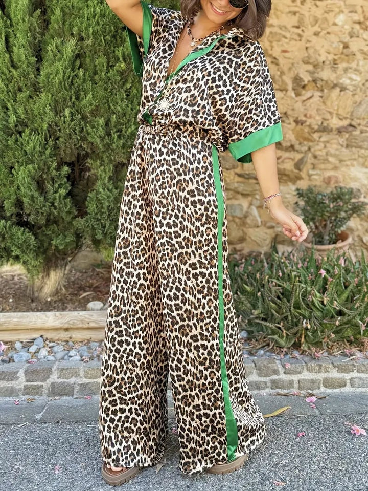 Model posing outdoors in the black leopard print two-piece set with wide-leg silhouette