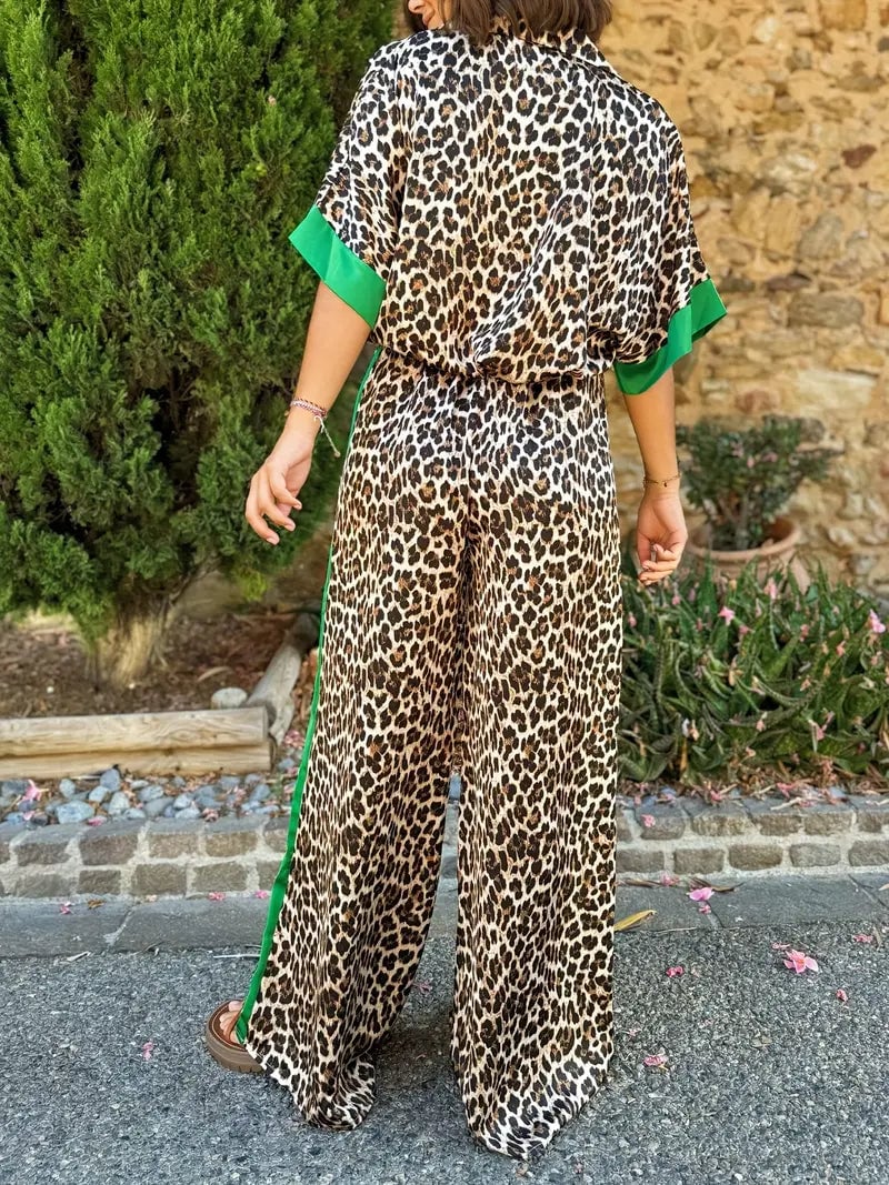 Side view of the fluid leopard print wide-leg set highlighting the flowing pant leg and loose top