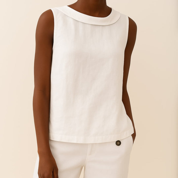 Flat lay of sleeveless roll collar top showing fabric texture and clean minimal design