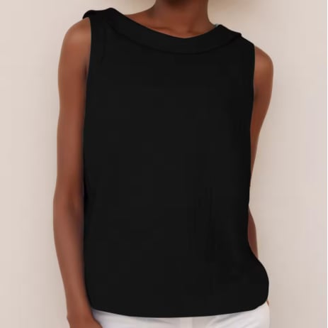 Woman wearing the sleeveless roll collar top in a relaxed outdoor setting
