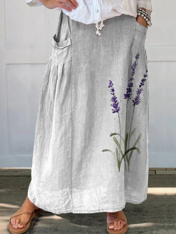 Watercolor lavender floral A-line skirt with elastic waistband and side pockets, shown in white with a flowing silhouette