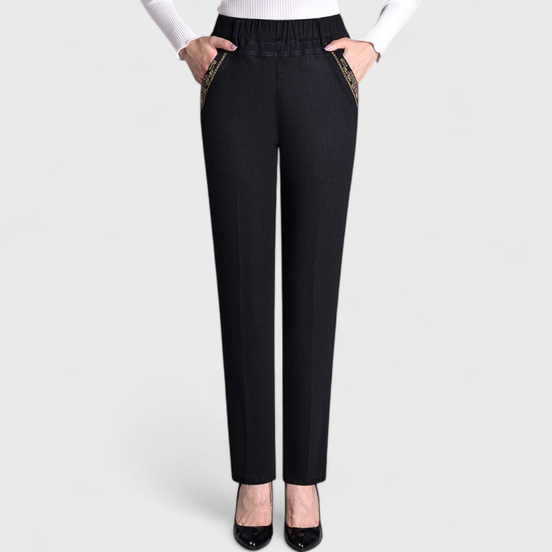 Close-up detail of elastic waistband and side pocket on women's stretch jeans