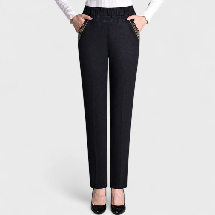 Close-up detail of elastic waistband and side pocket on women's stretch jeans