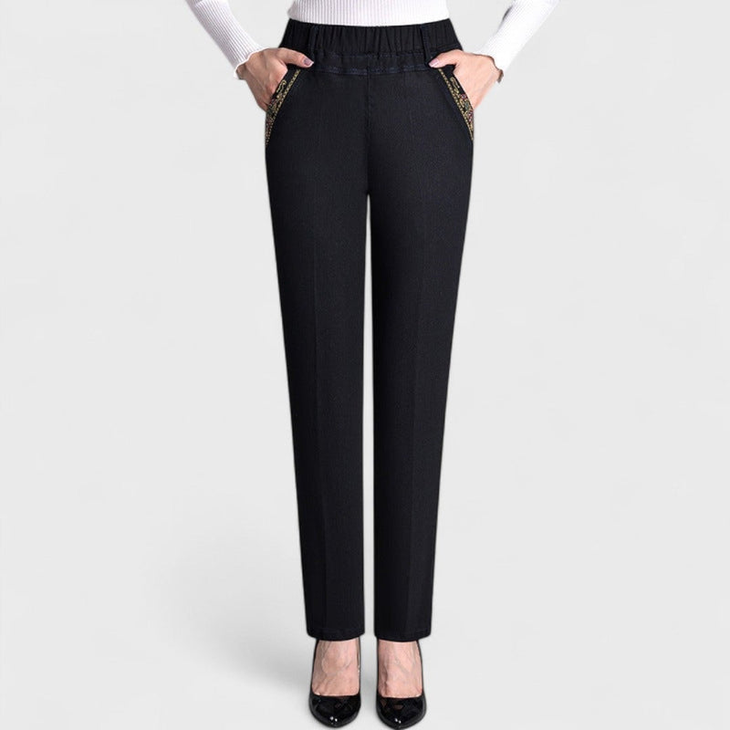 Close-up detail of elastic waistband and side pocket on women's stretch jeans