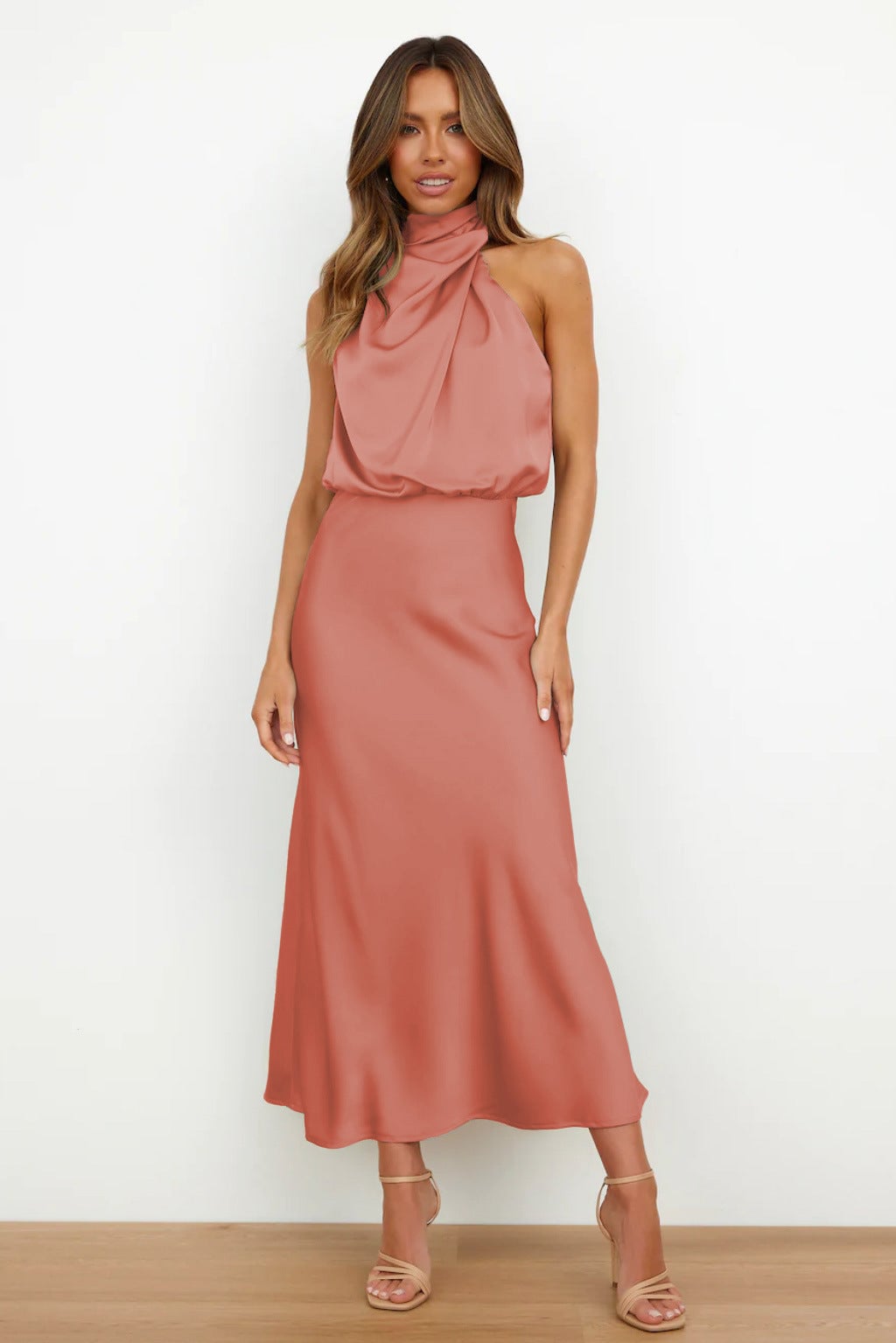 Marine blue satin halter evening dress on a model showcasing the flattering full-length silhouette
