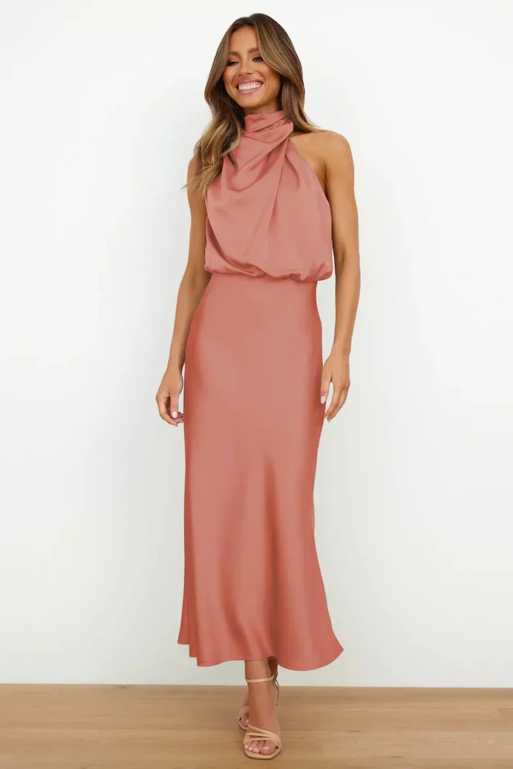 Dark green halter evening dress with a luxurious satin sheen and elegant flowing silhouette