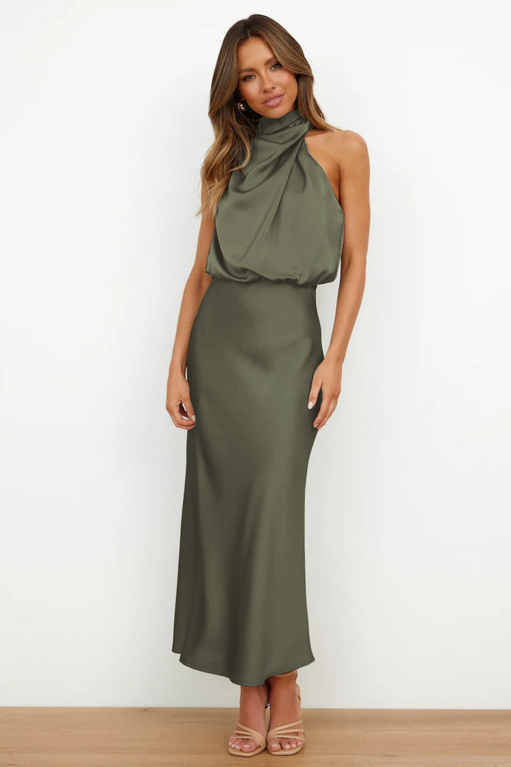 Model wearing a turquoise satin halter evening dress with a graceful floor-length skirt