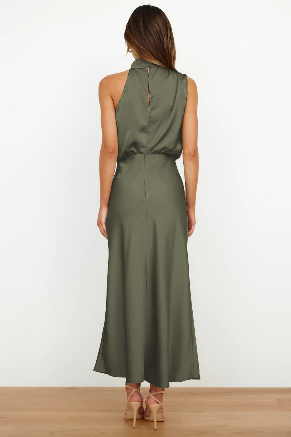 Back view of the satin halter evening dress showing the open halter tie and flowing fabric