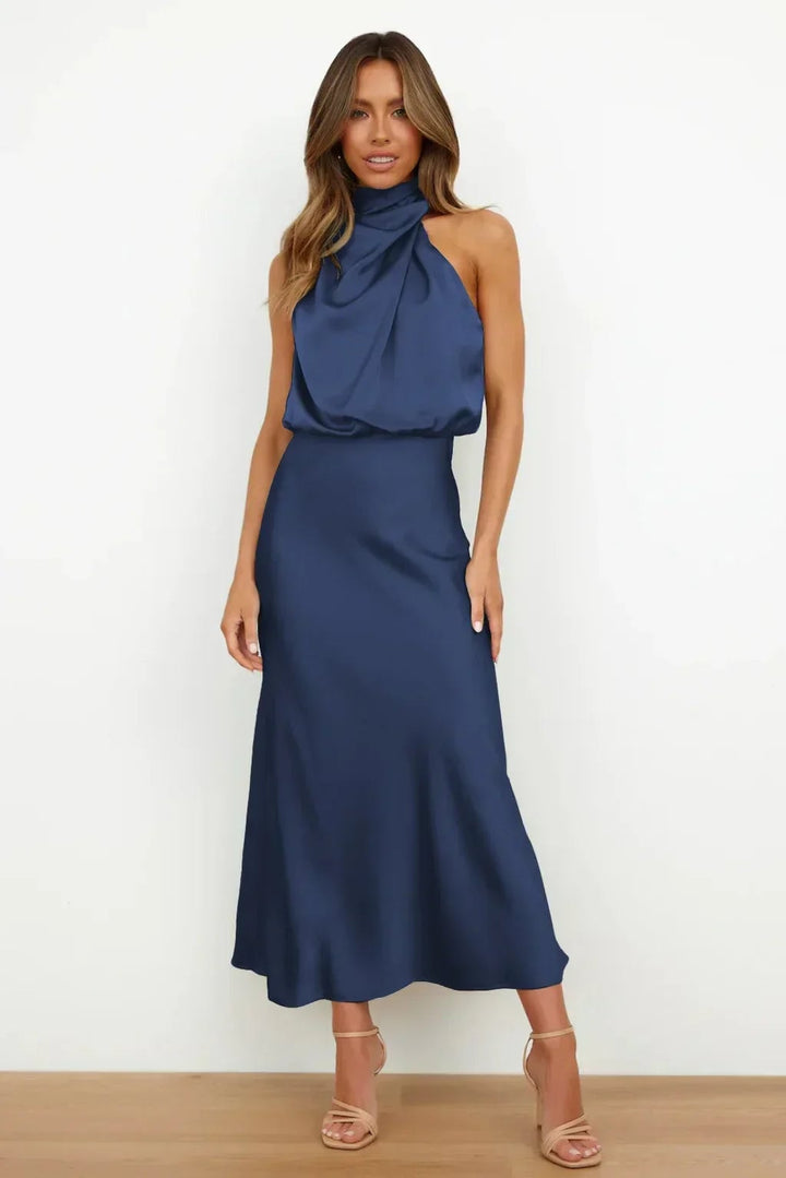 Side profile of the Mariana halter evening dress highlighting the fluid drape and elongated silhouette