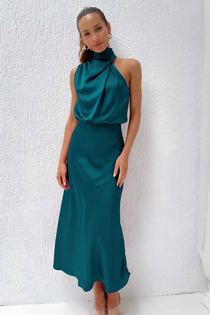 Close-up of the halter neckline and bodice of the satin evening dress in dark green