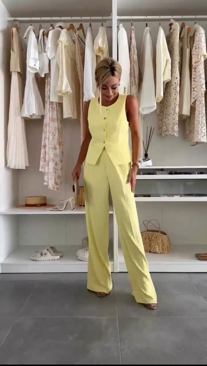 Model wearing the Maribel yellow two-piece co-ord set with button-up top and matching pants, front view