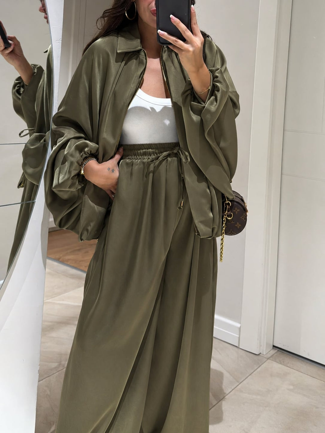 Woman in brown Maribel set styled with sneakers, casual everyday look