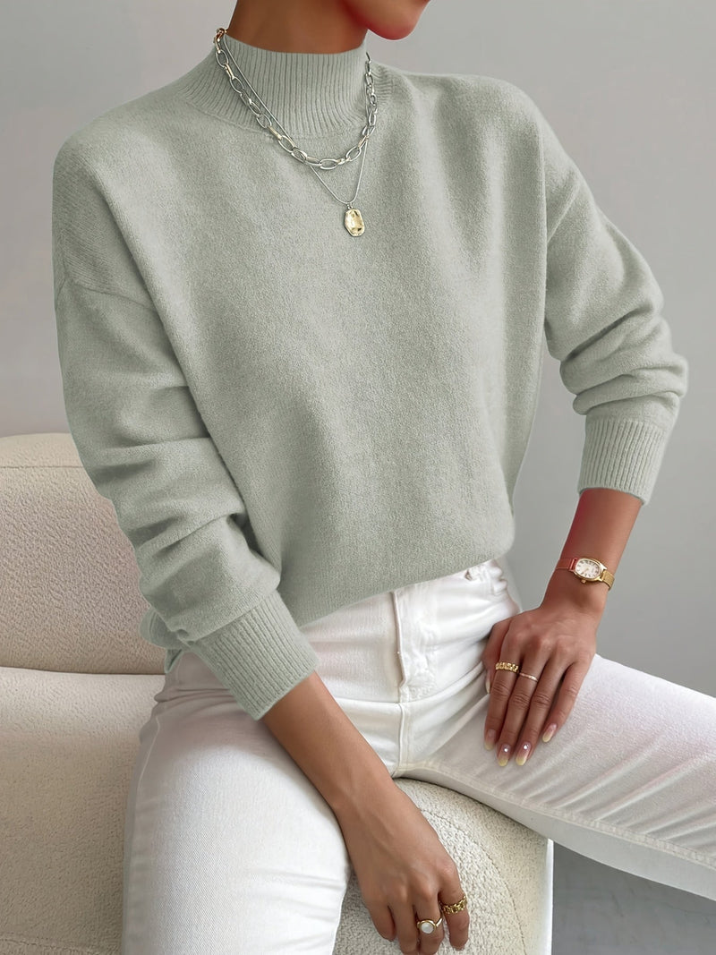 Woman wearing an elegant turtleneck sweater in a soft neutral color, styled for a polished everyday look