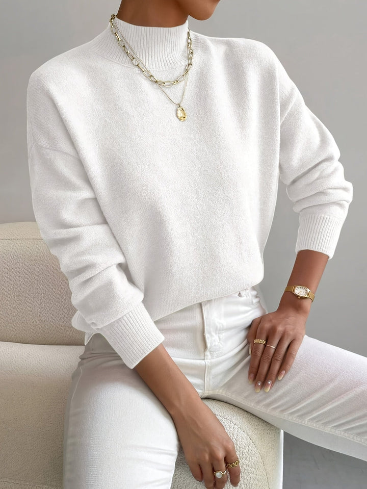 Close-up of a classic turtleneck sweater showing flattering fit and clean neckline detail