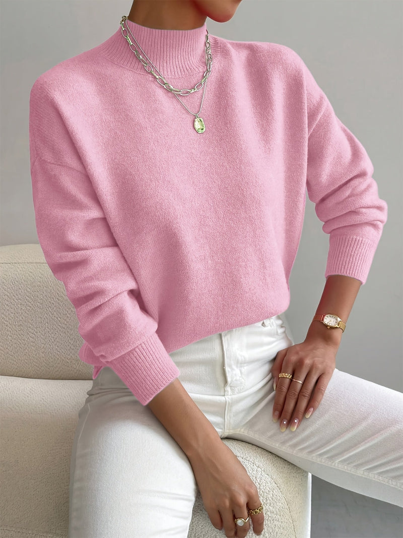 Model in a cozy turtleneck sweater paired with tailored bottoms for an effortless chic outfit
