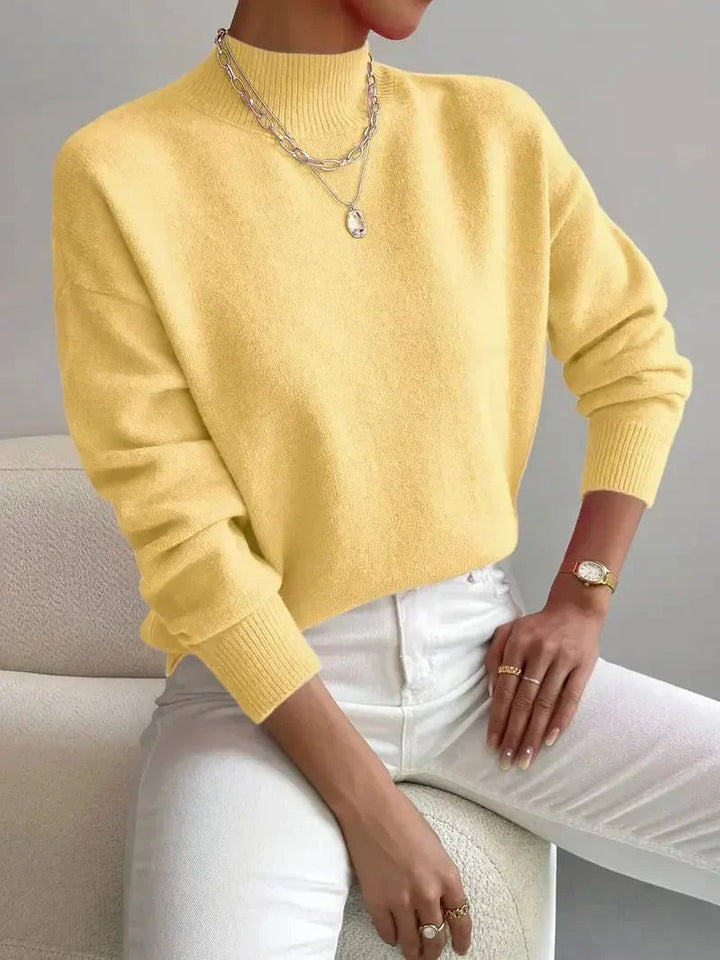 Turtleneck sweater in light green displayed on a model, highlighting the elongating neckline silhouette