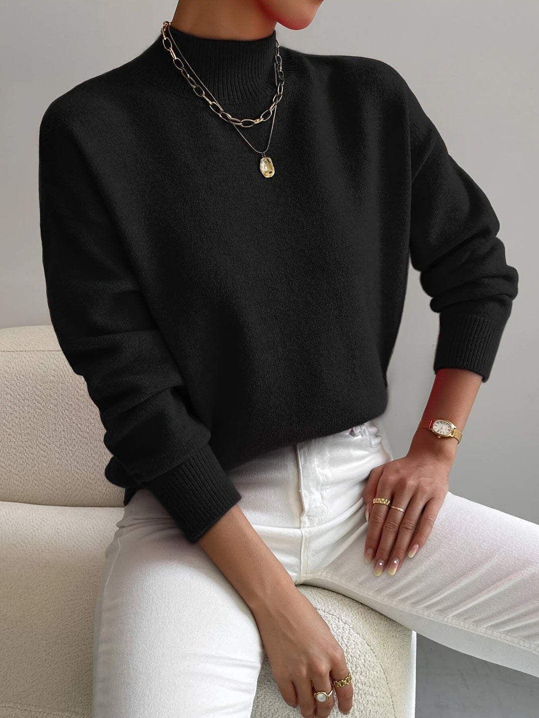 Light pink turtleneck sweater on a model, showcasing the comfortable flattering fit