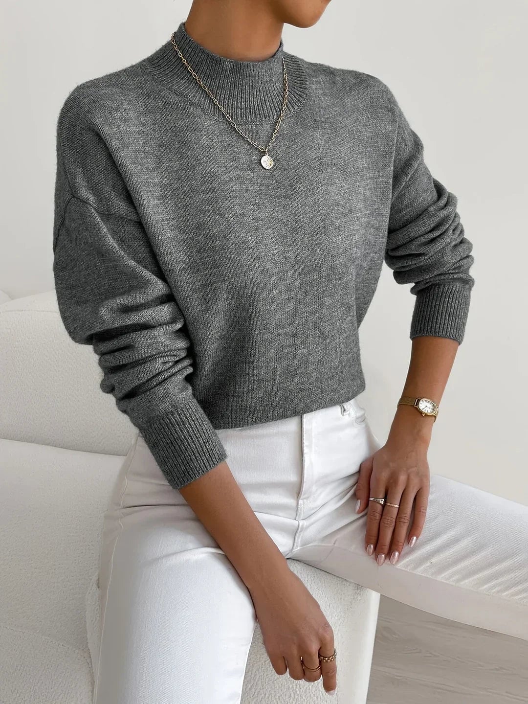 Black turtleneck sweater worn by a model, versatile and timeless for work or weekend outfits