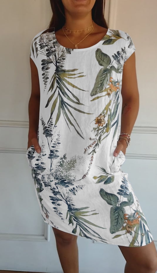 Woman wearing the Marilyn round neck dress in a soft neutral color, styled for a casual daytime look