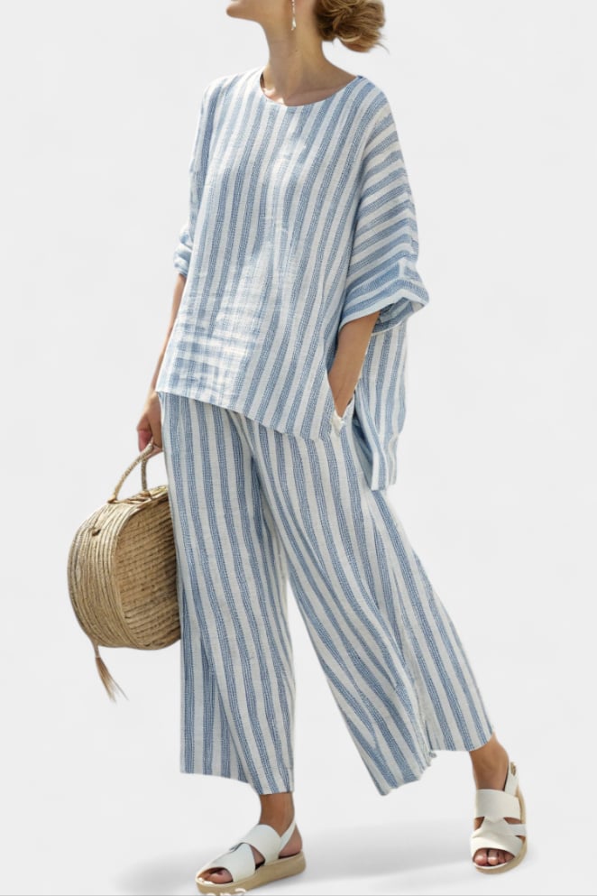 Woman wearing a blue and white vertical stripe oversized boxy top and wide-leg cropped pants set, front view