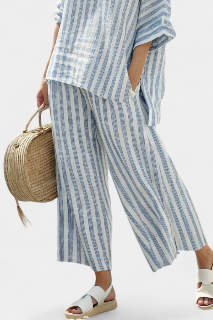 Close-up of the Marina striped set showing the round neckline, chest pocket detail, and vertical blue stripe print