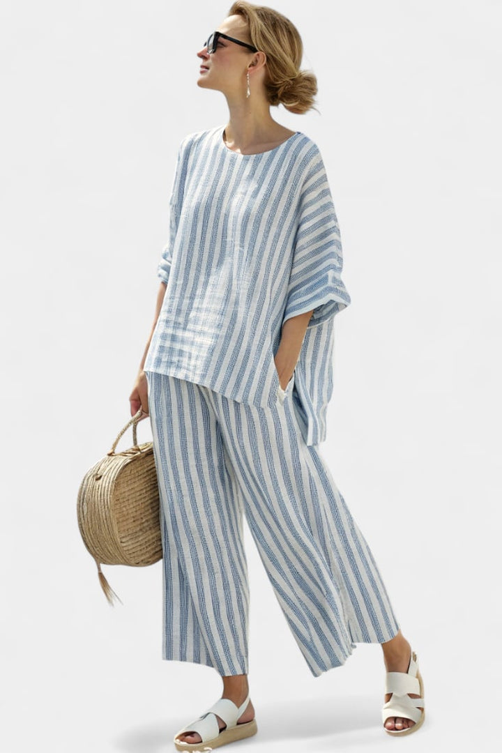 Full-length side view of the Marina striped wide-leg pants set styled with flat sandals for a coastal casual look