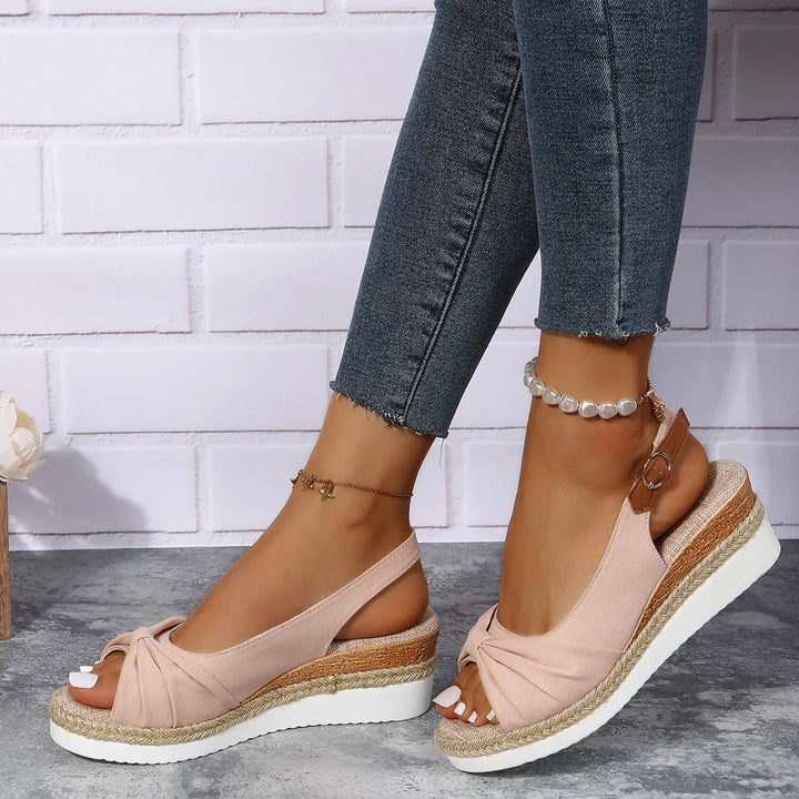 Overhead flat lay of all four Marinette sandal colors: black, beige, blue, and pink