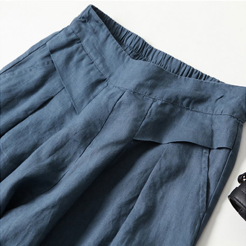 Model wearing blue wide-leg relaxed pants paired with strappy sandals