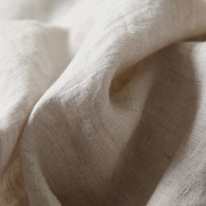 Detail of fabric texture and drape on wide-leg relaxed pants in black