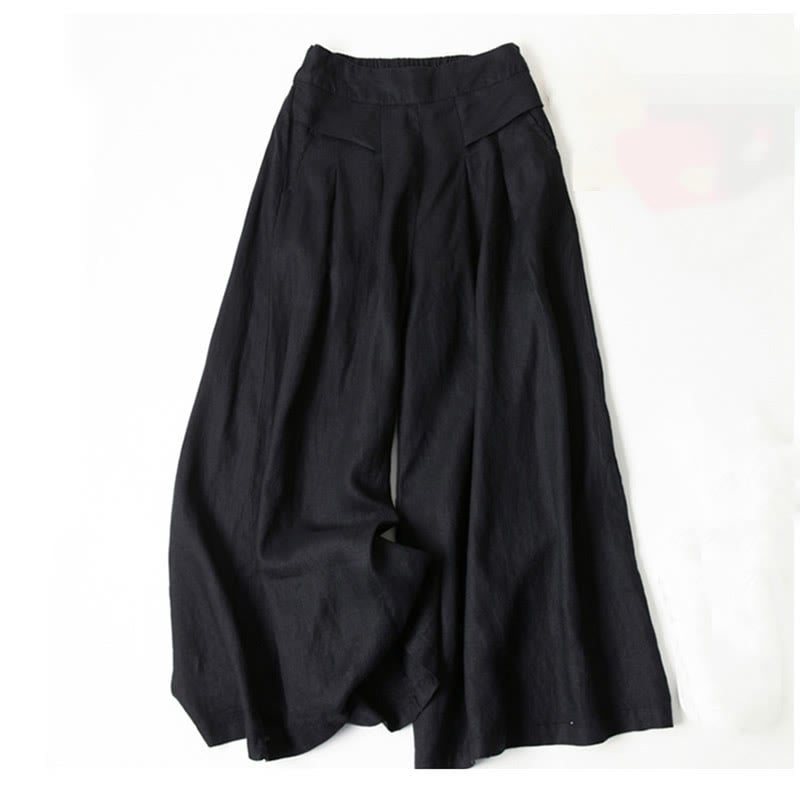 Close-up of waistband and high-rise fit on beige wide-leg relaxed pants