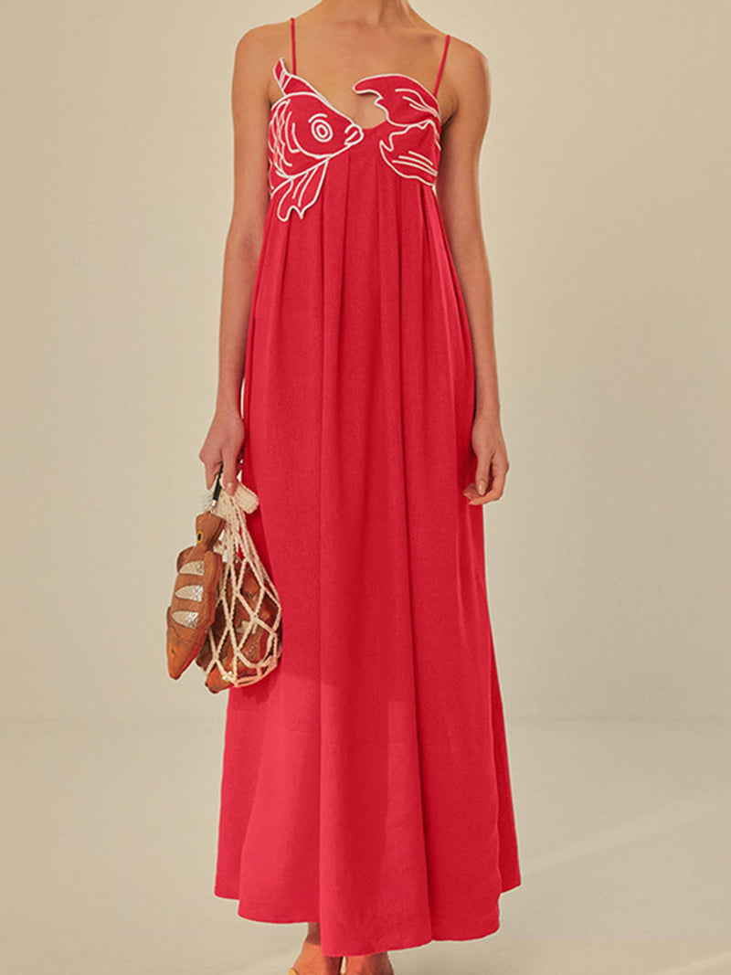 Woman wearing a red embroidered spaghetti strap maxi shift dress in a relaxed summer setting, front view